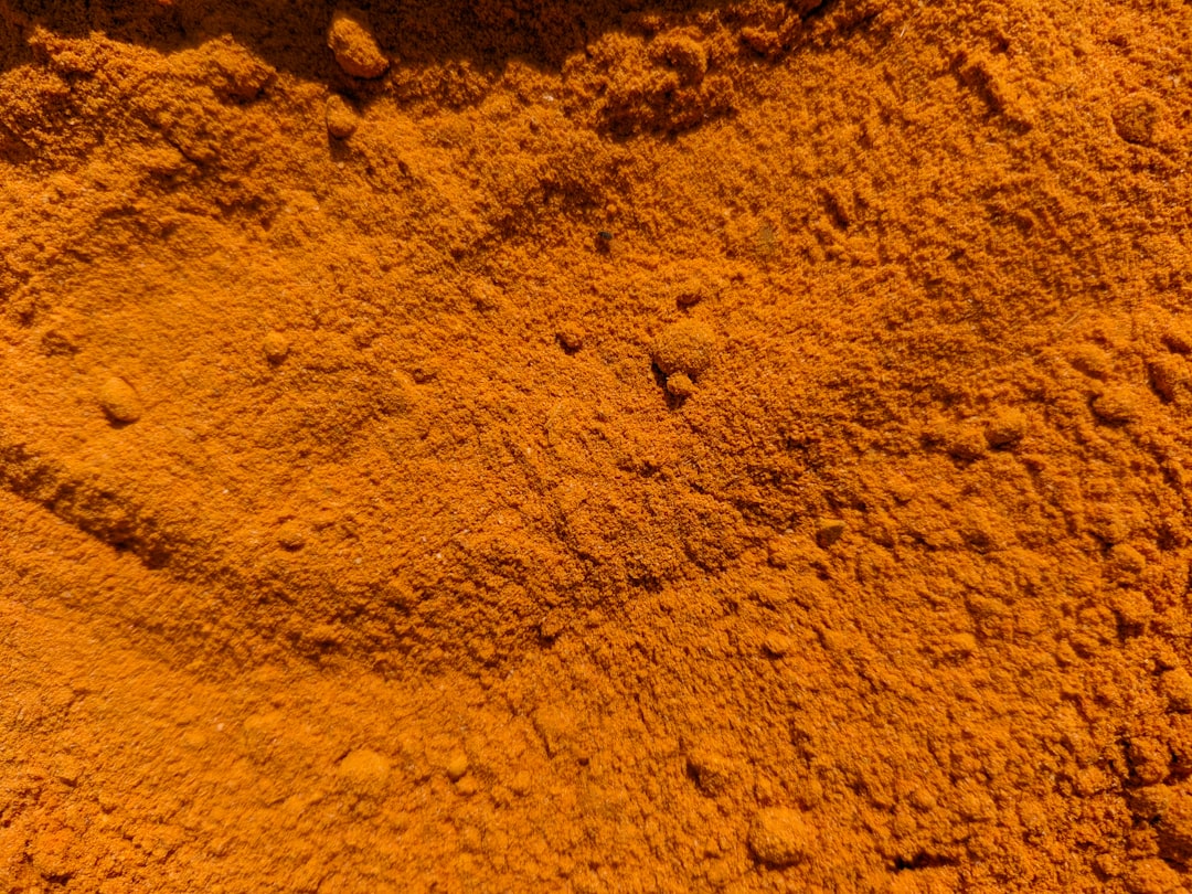 Golden turmeric powder close-up showing the vibrant anti-inflammatory spice