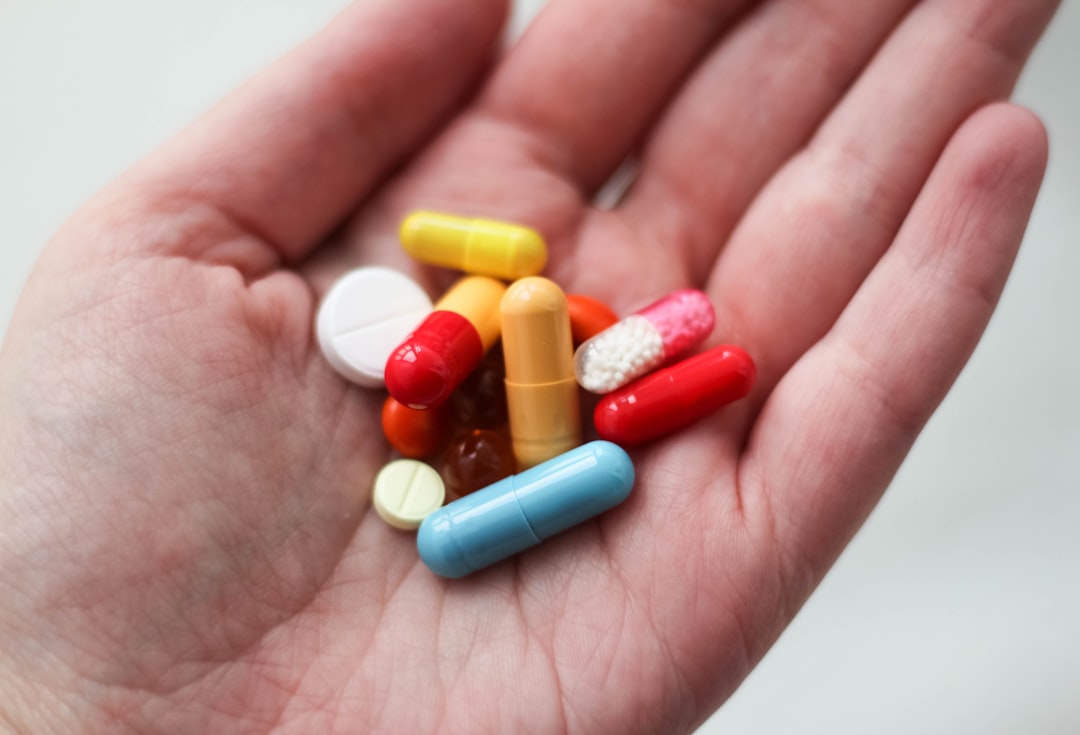 Daily supplement pills in hand representing a consistent wellness routine