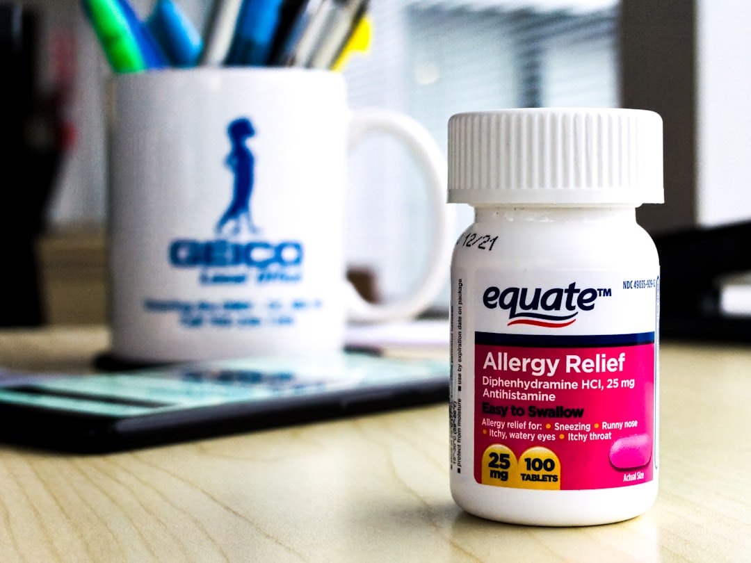 Bottle of allergy relief tablets on a desk