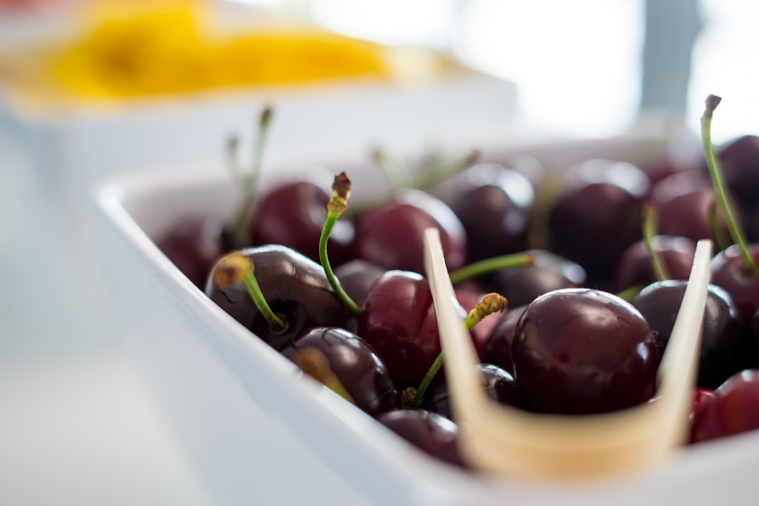 A bowl of fresh dark cherries on a kitchen counter