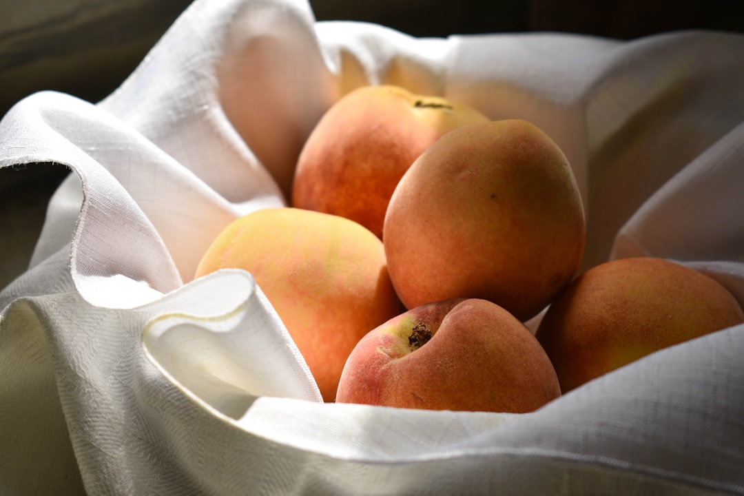 Basket of fresh ripe peaches at a farmers market