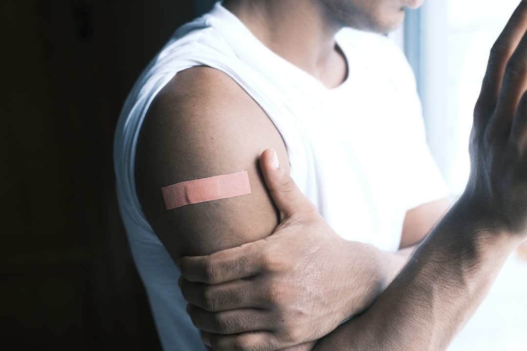 Man applying medical tape carefully