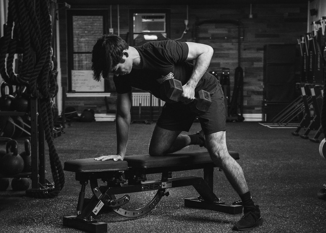 Man performing a dumbbell row during a strength training session