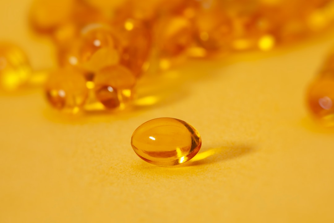 Vitamin D supplement bottle with softgels on a table