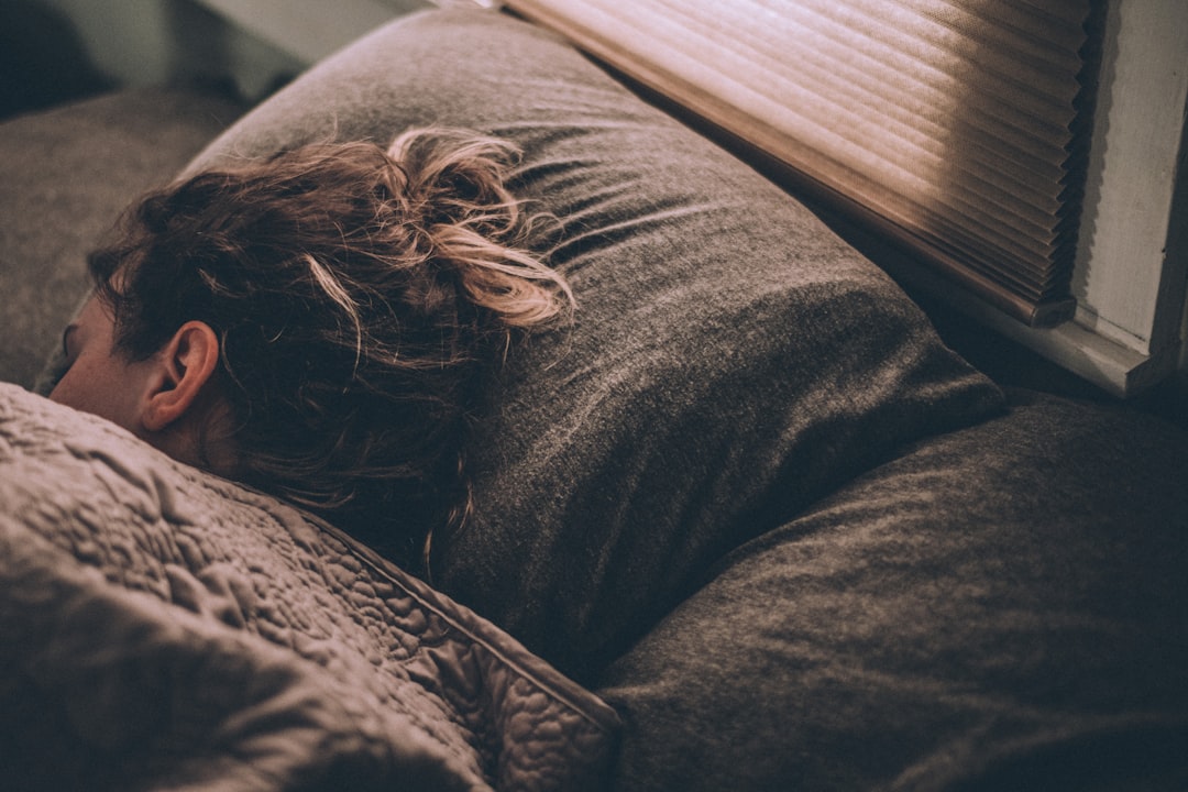 Woman sleeping peacefully in bed with soft morning light