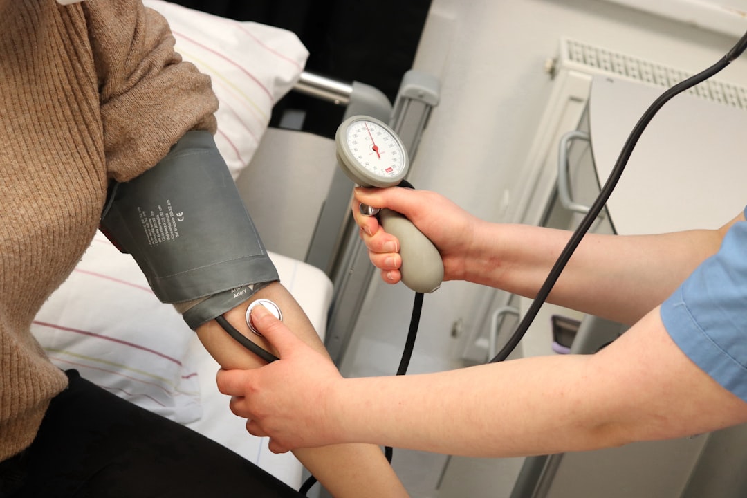 Nurse measuring a patient's blood pressure with a cuff in a clinical setting