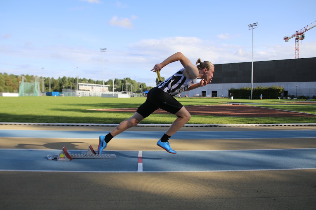 Sprinter exploding out of the starting blocks on a track