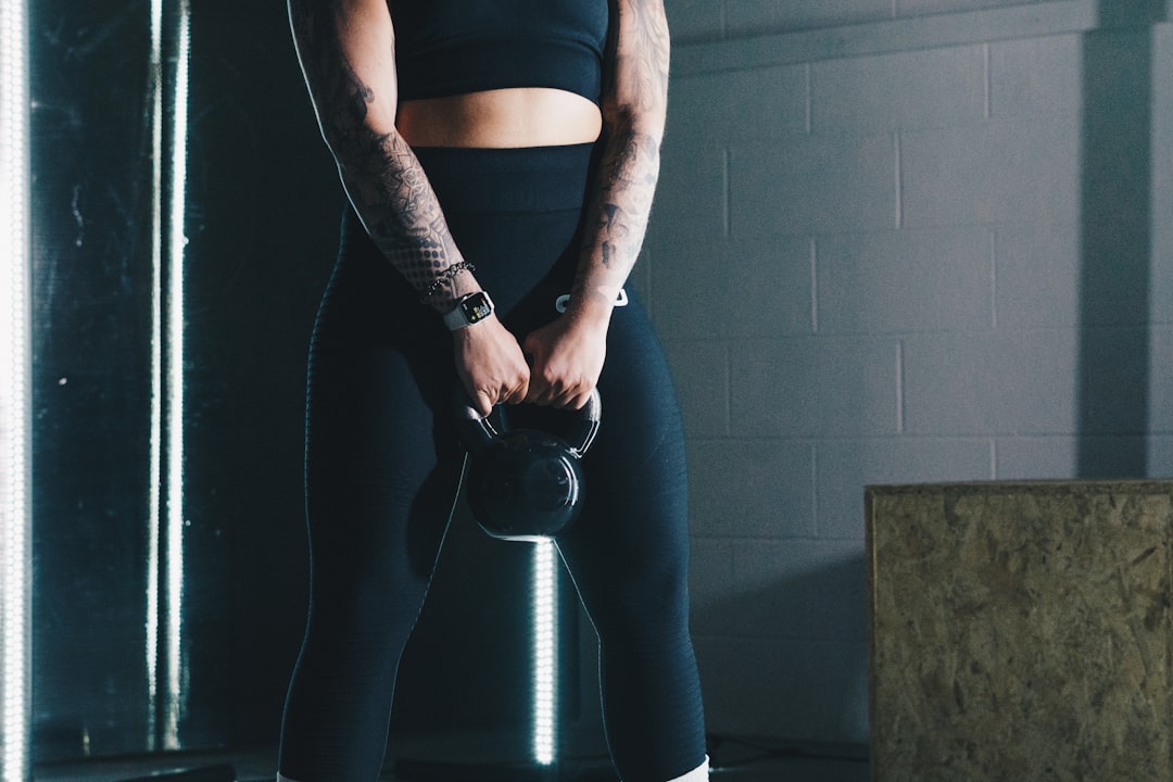 Woman training with a kettlebell during a home workout