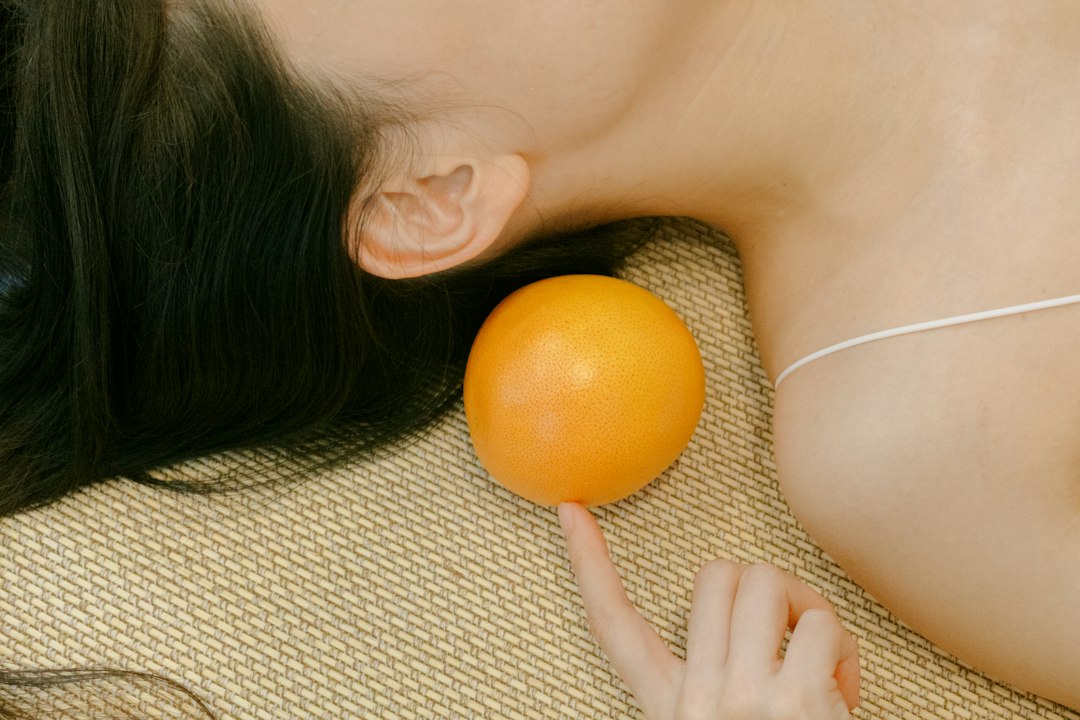 Woman lying down using a round roller under her neck