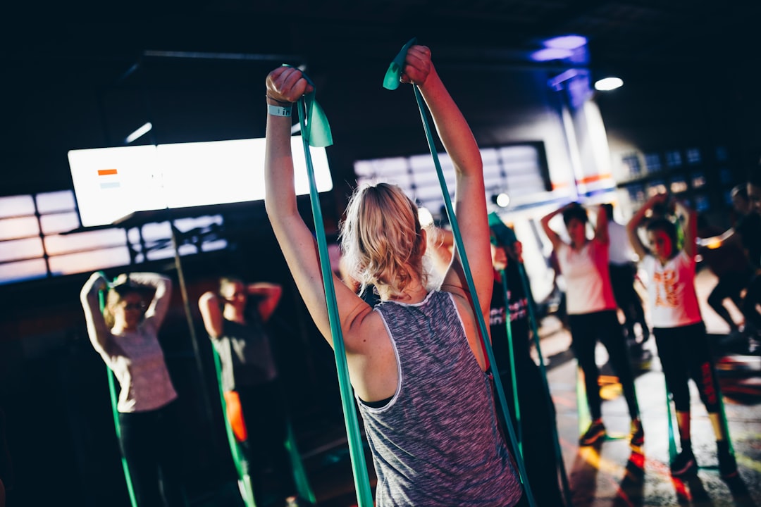 Woman training with green resistance bands in a fitness class