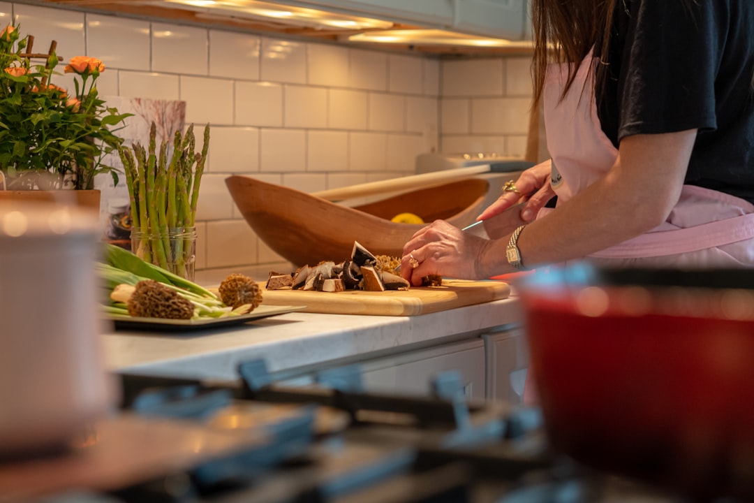 Woman chopping fresh vegetables in a bright home kitchen