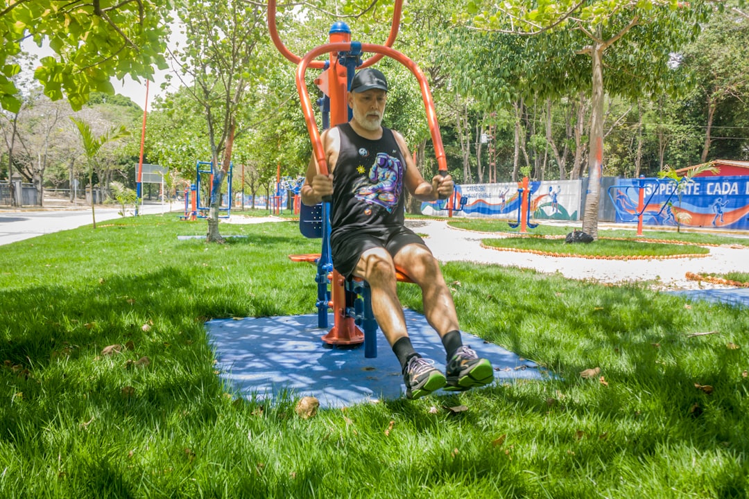 Senior man training on outdoor gym equipment