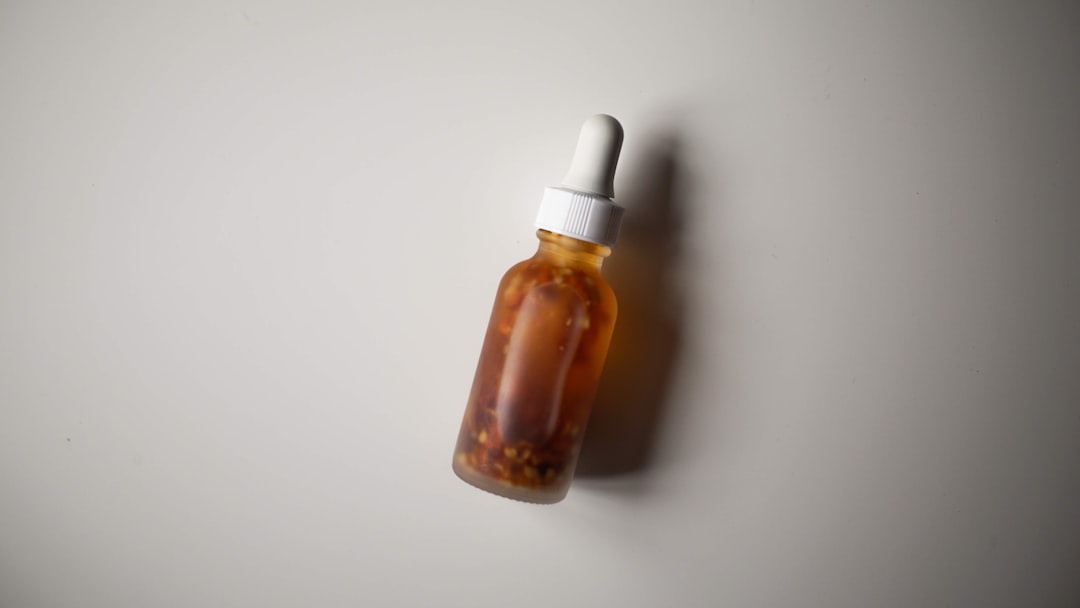 Amber glass dropper bottle of liquid vitamin supplements