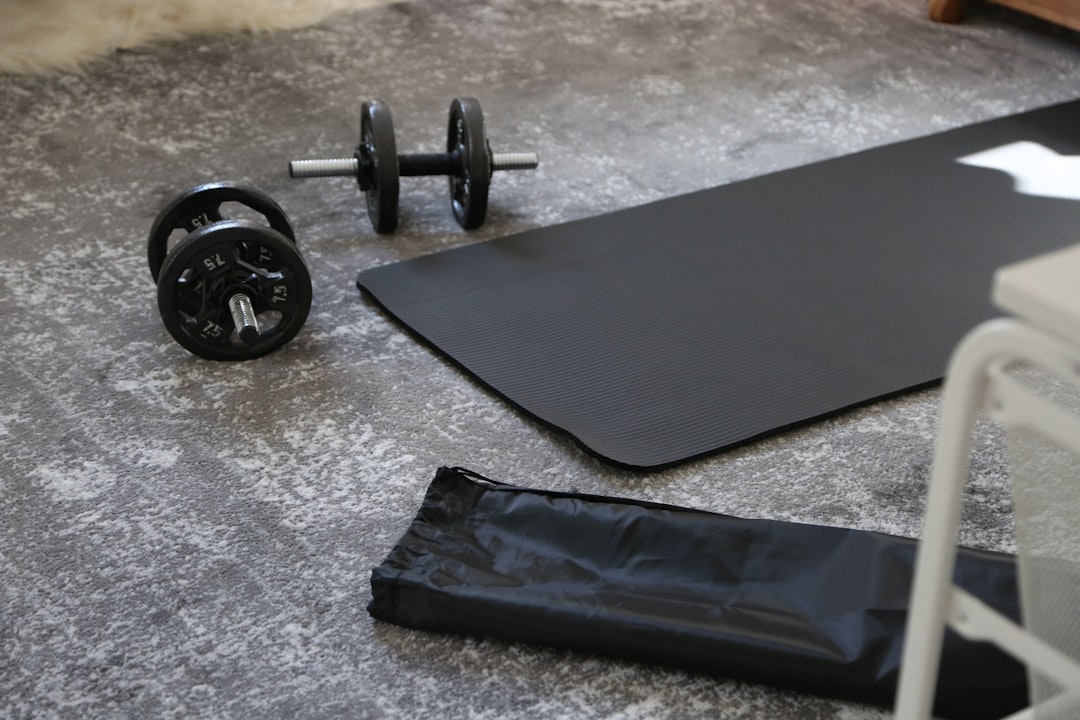 Exercise mat and dumbbells on a home floor