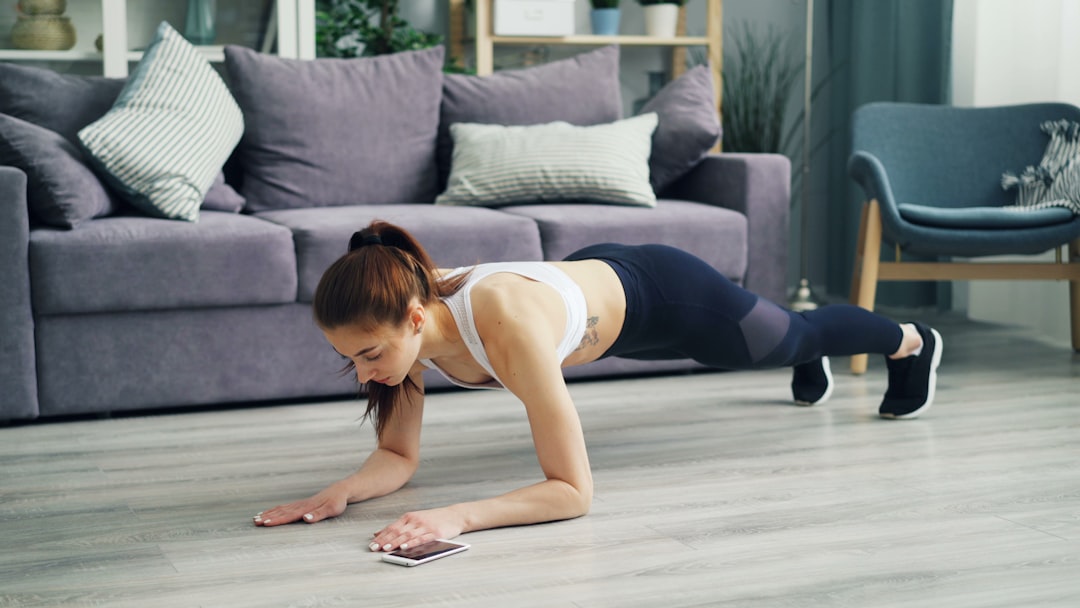 Woman doing a plank in a small living room home workout