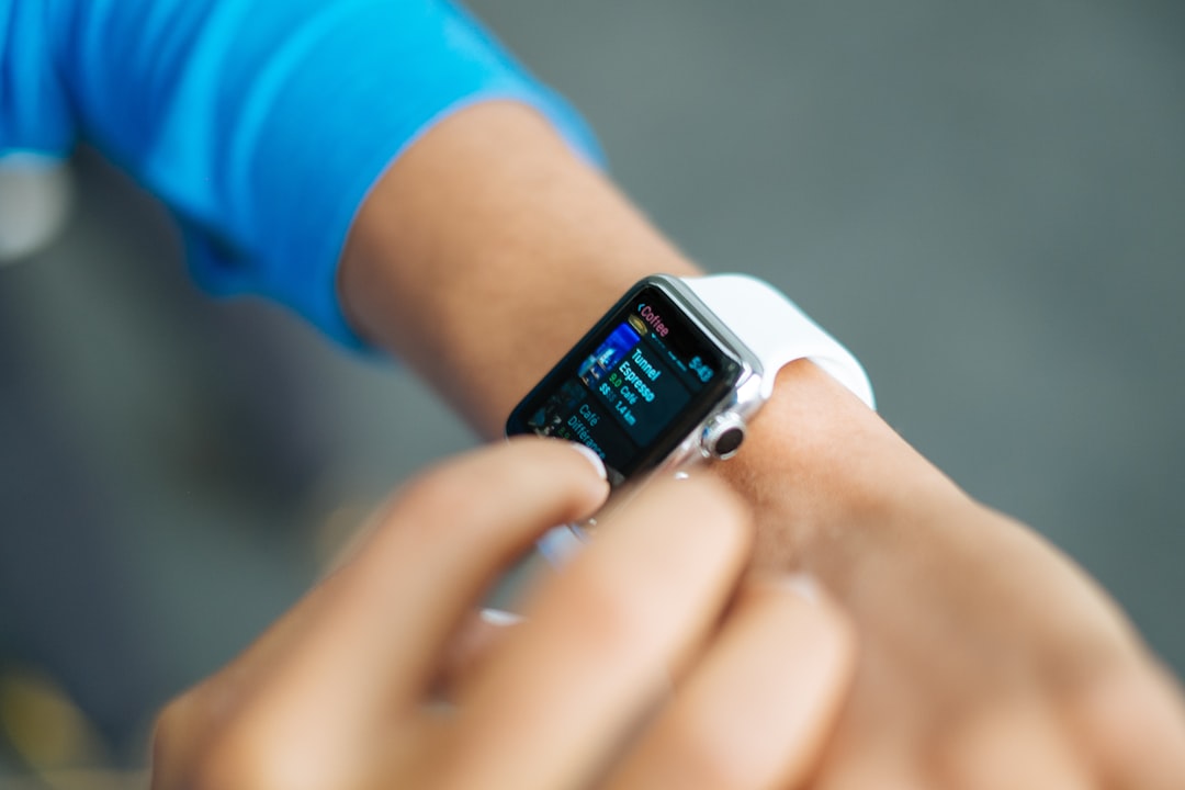 A runner checking a smartwatch that syncs with health devices