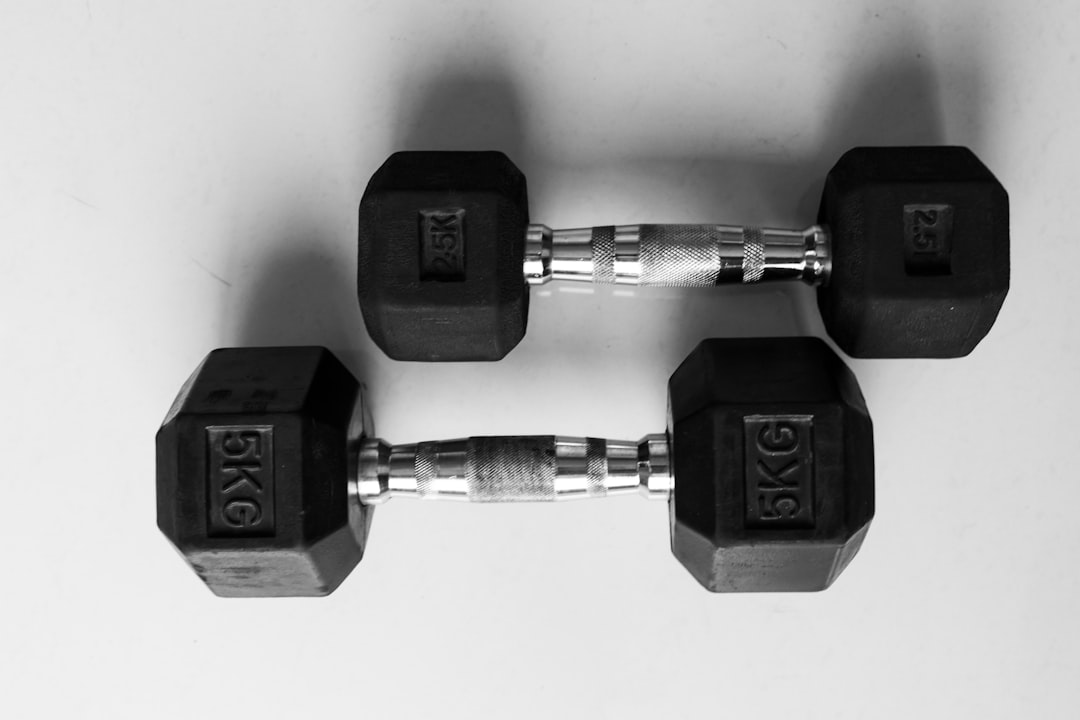 Pair of cast-iron dumbbells resting on a clean surface