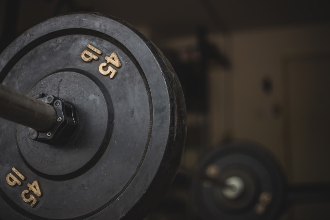 Close-up of 45 pound barbell weight plates loaded on a bar