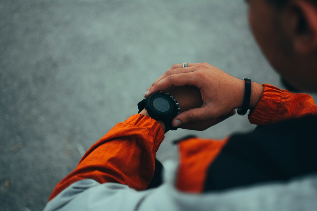 Runner checking sports watch during a training run