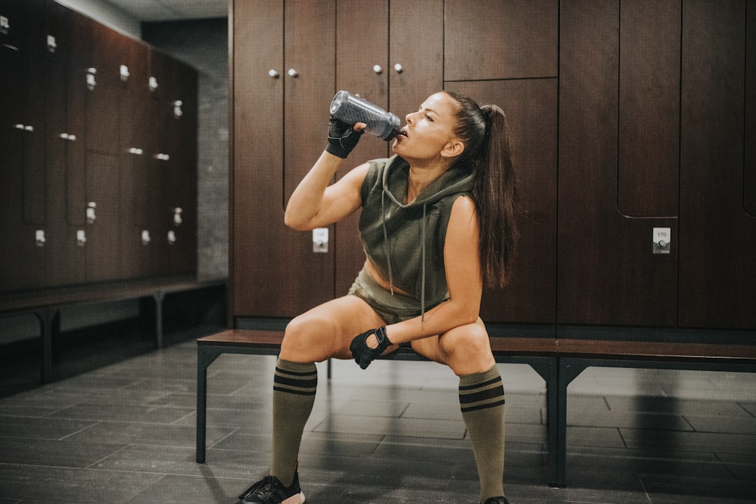 Woman drinking water after a gym workout