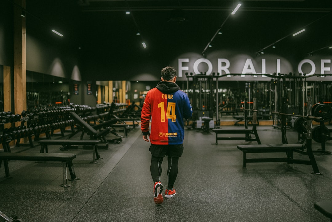 Weight benches and racks lined up inside a training facility