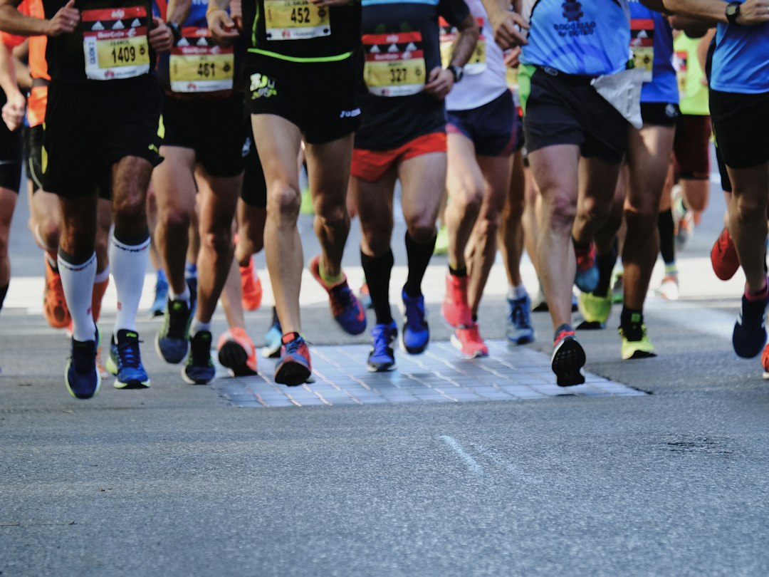 Runners mid-race wearing colorful racing shoes