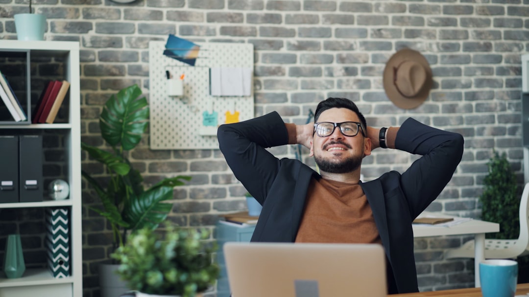 Office worker stretching at his desk during the workday