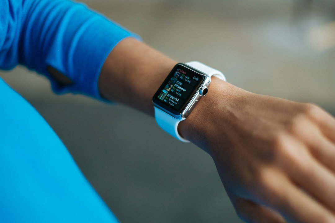 Runner pausing to check data on an Apple Watch