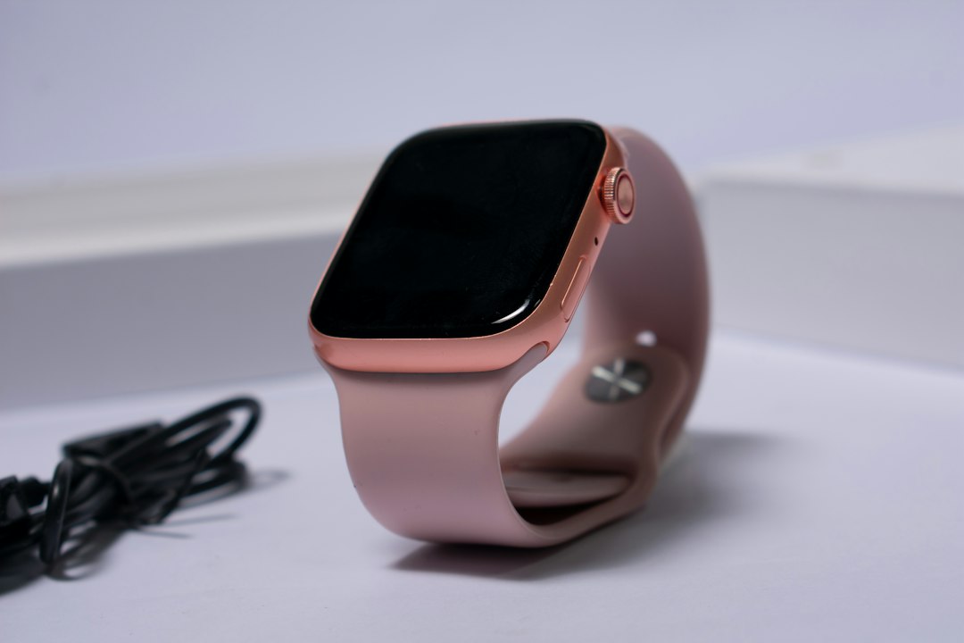 Smartwatch resting beside its charging cable