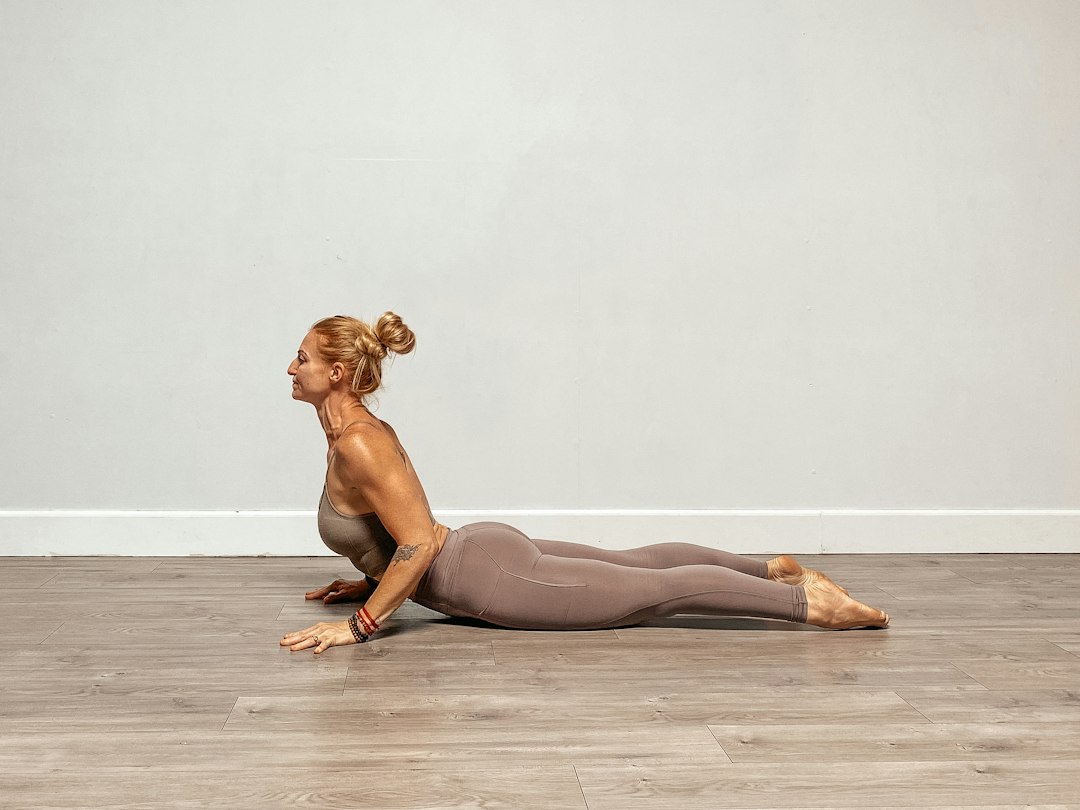 Person practicing a cobra stretch pose on a mat