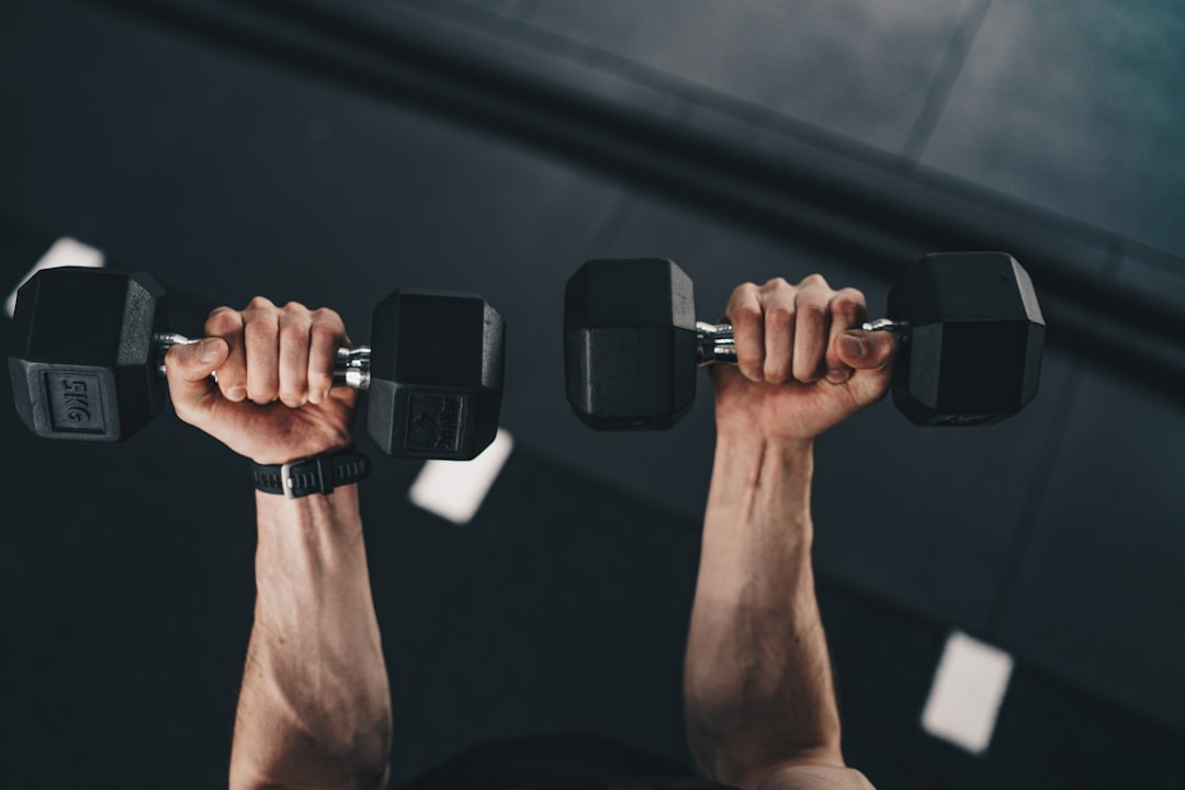 A pair of dumbbells held ready for a strength training session
