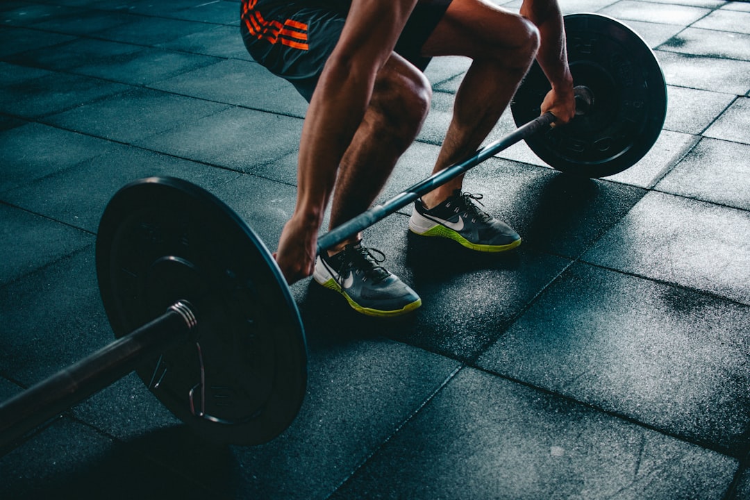 Athlete performing a powerful deadlift hinge with a barbell
