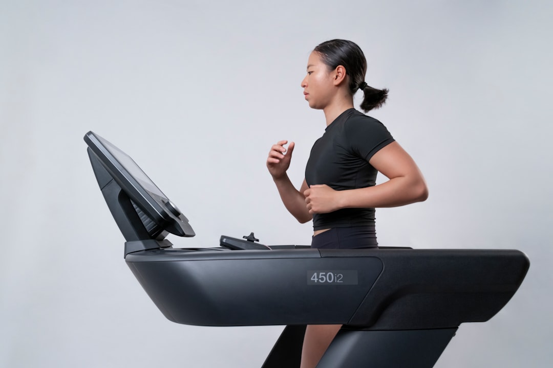 Woman training on a treadmill at home in a bright studio space