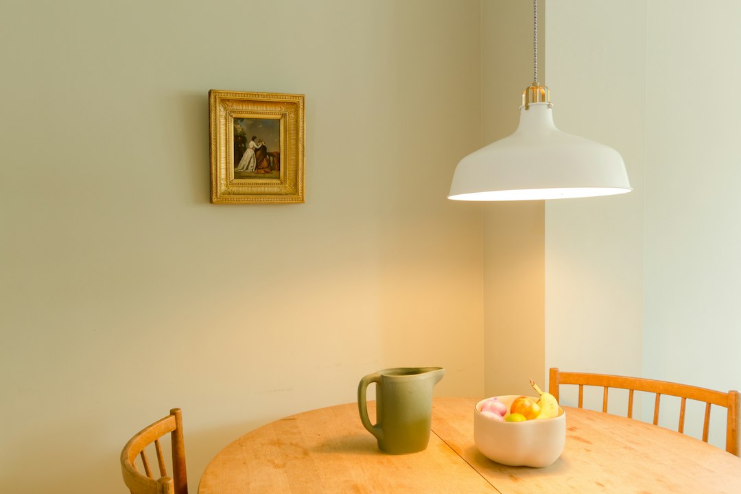 Bright pendant lamp glowing over a breakfast table with fruit