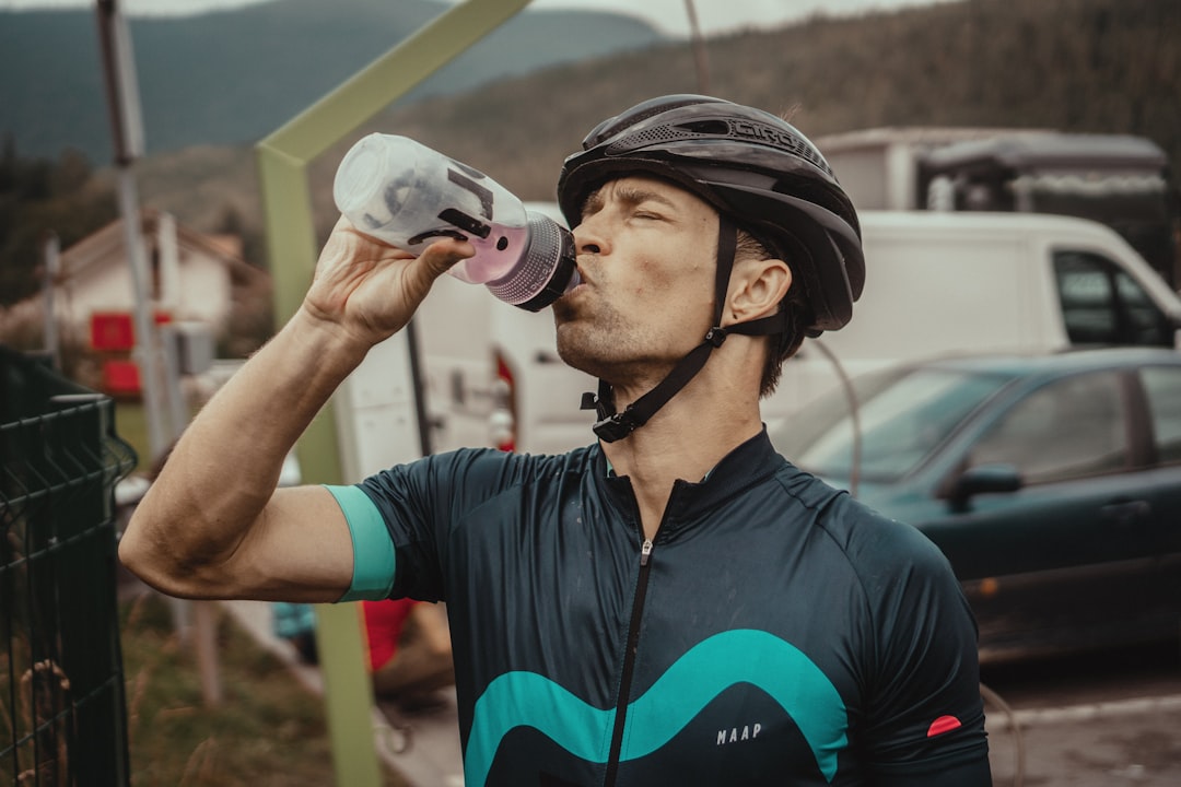 Cyclist drinking from a bottle during a ride