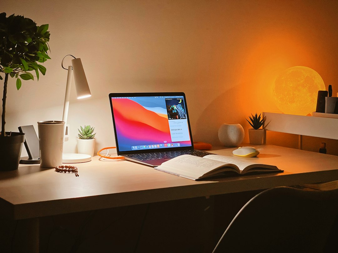 A warm glowing lamp on a desk in soft morning light