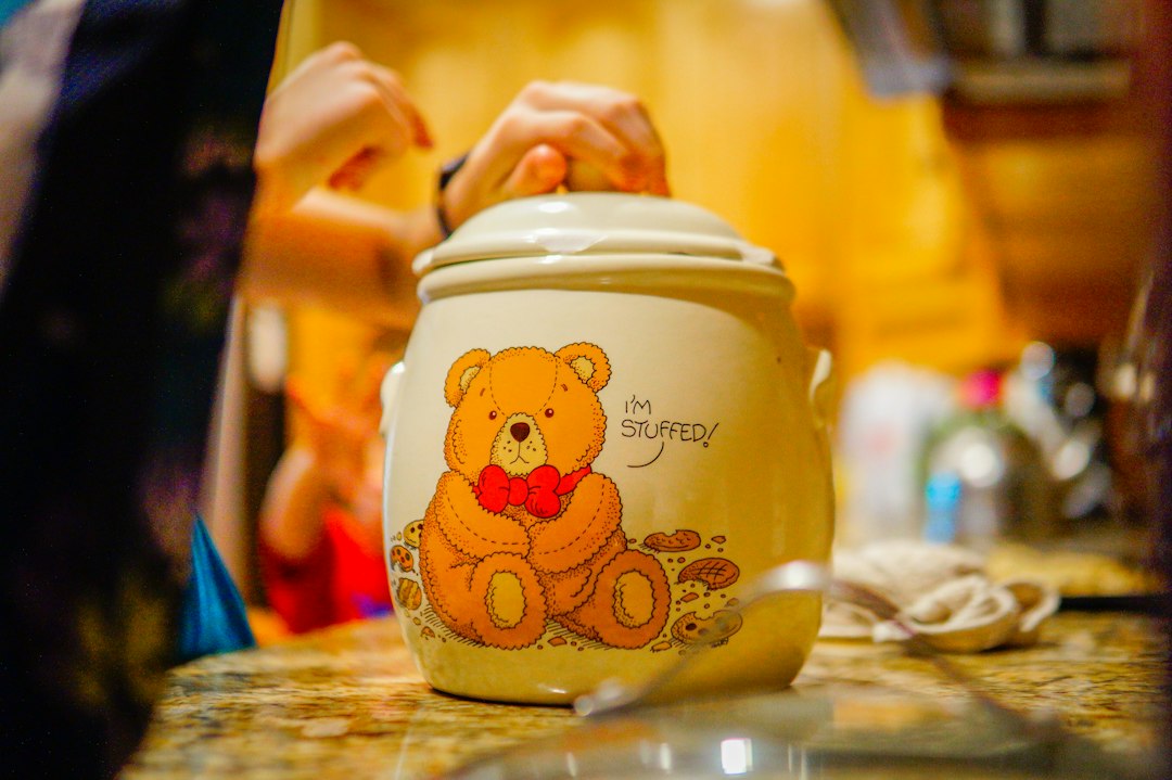 Hands lifting the lid off a kitchen jar — the everyday grip test that matters at eighty