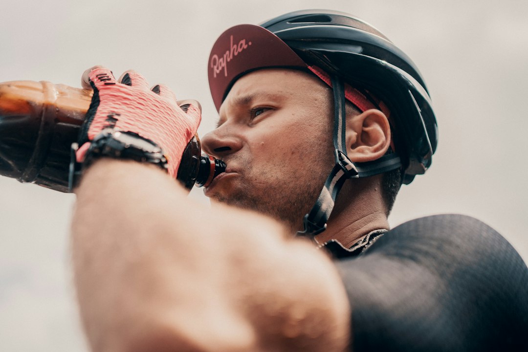 Athlete drinking from a bottle during an outdoor ride