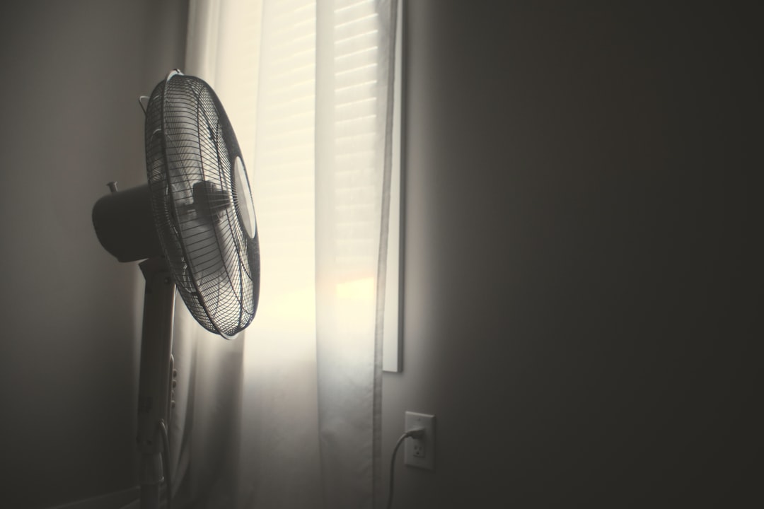 Standing fan keeping a bedroom cool at night