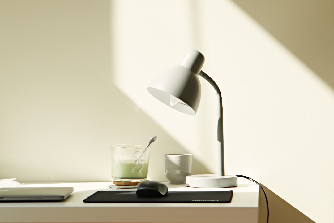 Light therapy lamp glowing on a desk during a dark winter morning