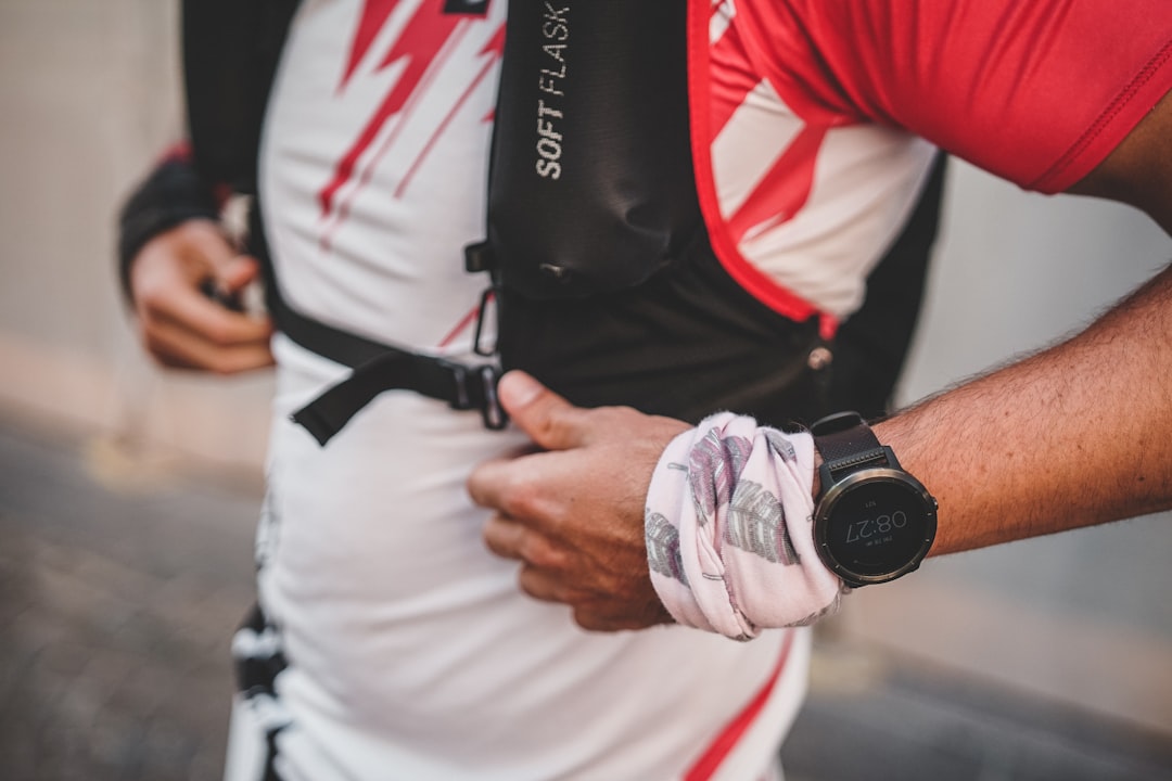 Trail runner wearing a hydration vest with soft flasks