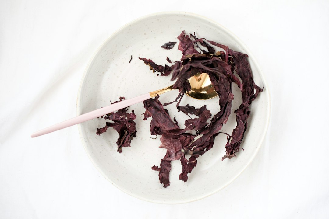 Bowl of dried purple beetroot powder with a spoon