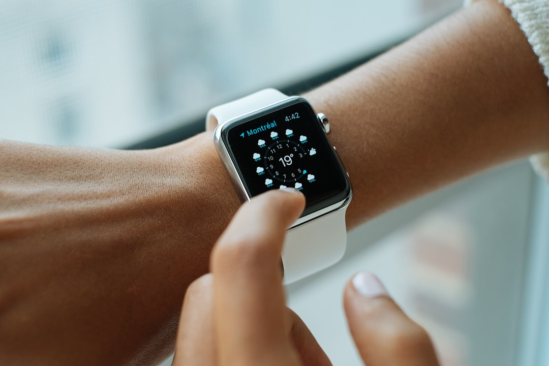 Close-up of a fitness tracker on a wrist showing daily stats