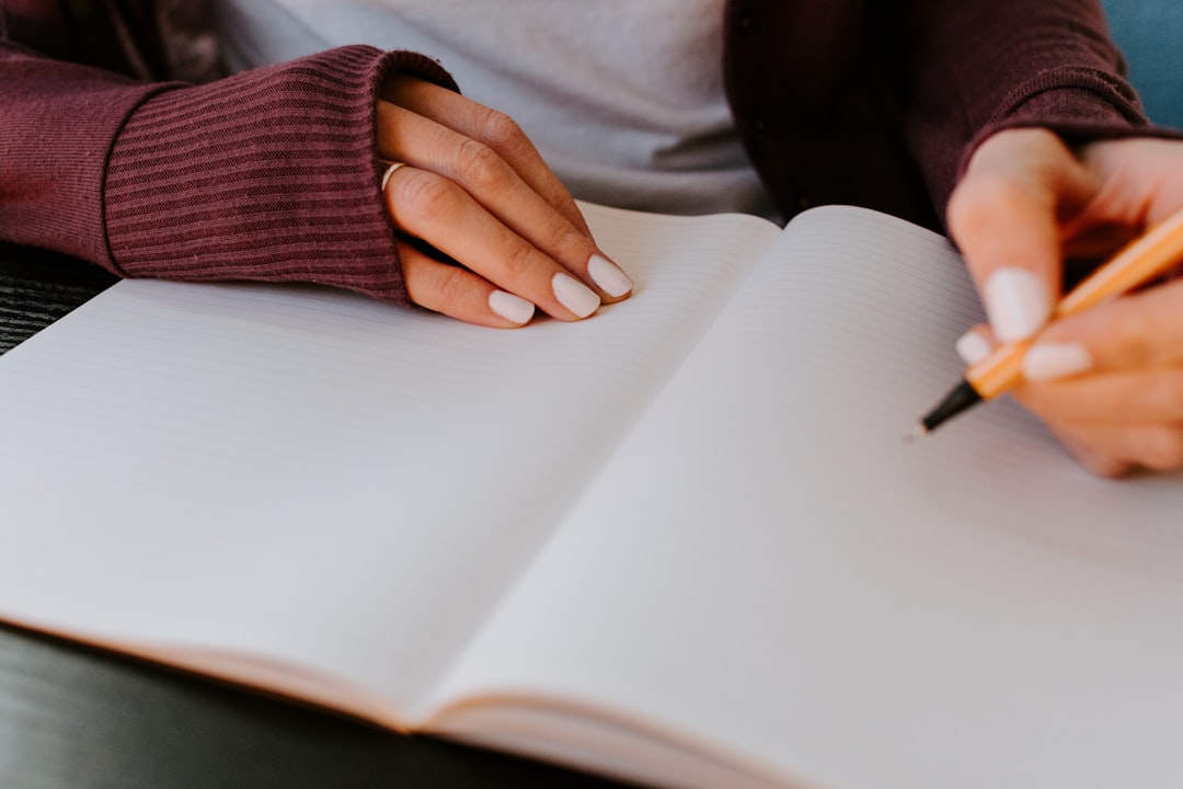 Woman journaling health symptoms in a notebook