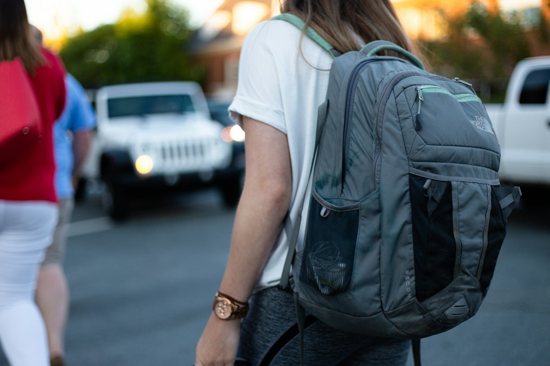 Walker carrying a weighted backpack on an evening walk