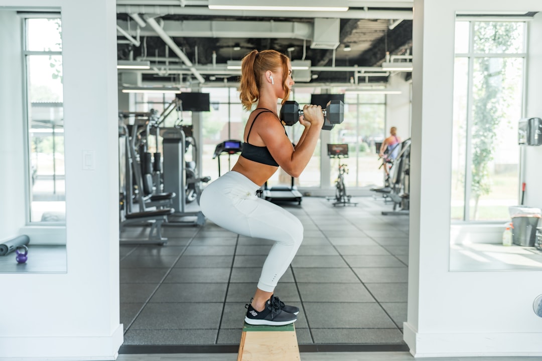 Woman performing a weighted squat during a training session