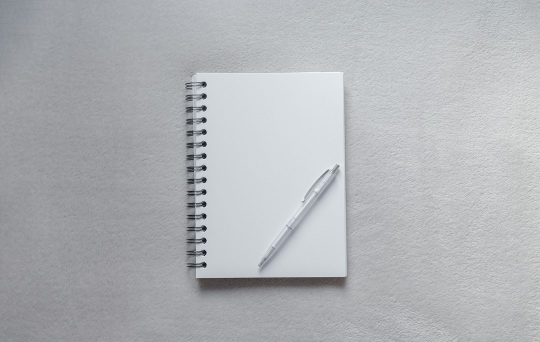 A notebook and pen resting on a table for tracking habits