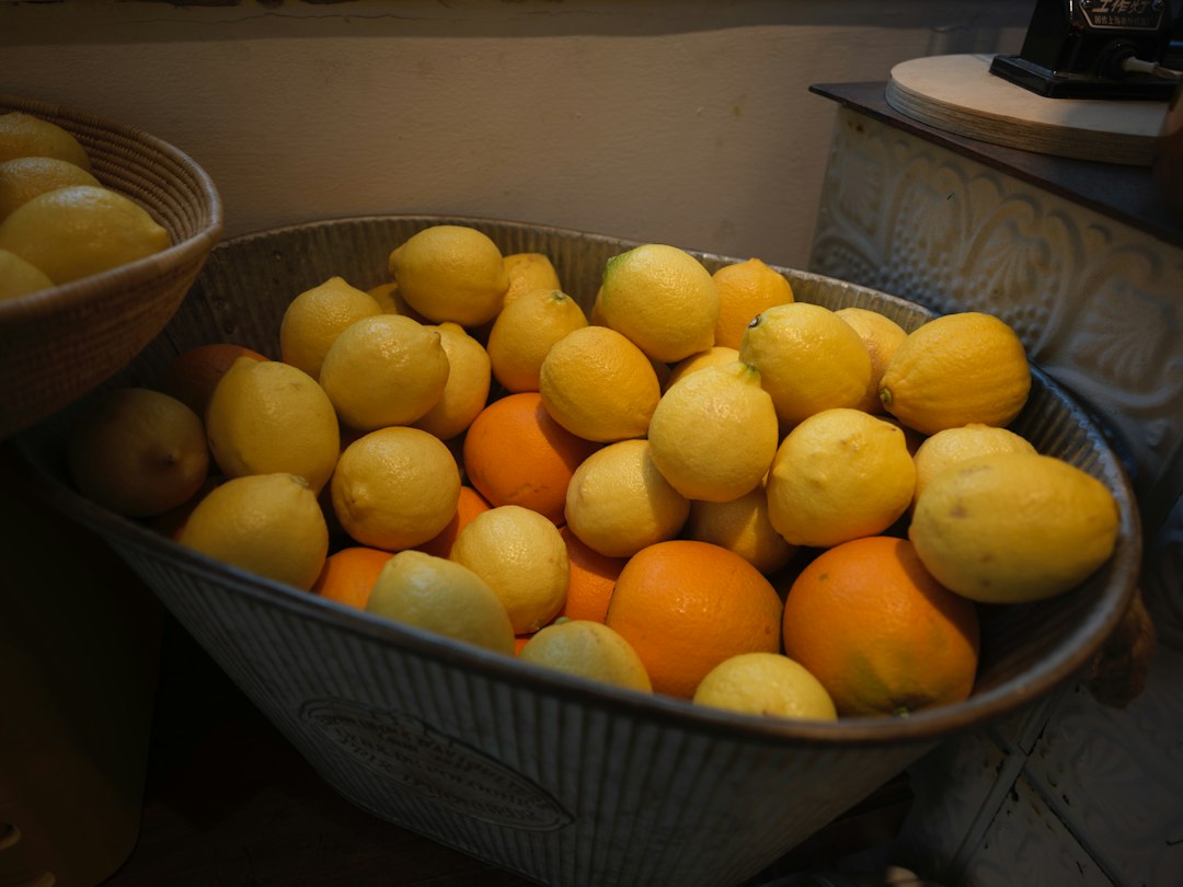 A metal tub filled with lemons and oranges
