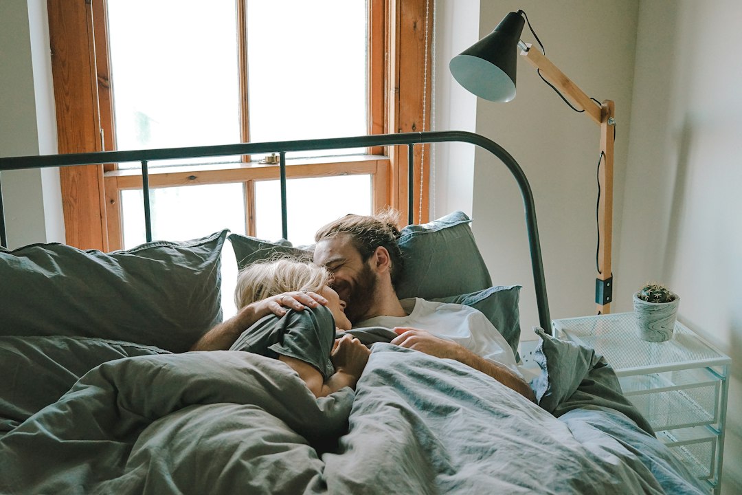 Father and child napping together under heavy bedding