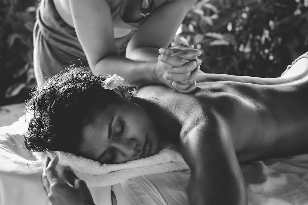 Woman receiving a deep back massage on a treatment table